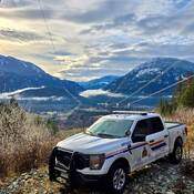 Police truck overlooking the Village of Pemberton with mountain backdrop