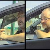A man is holding a knife while sitting in the driver’s seat of a vehicle. A man wearing glasses is leaning out his driver’s side window.