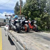 Three motorcycles on a tow truck after they were impounded for excessive speed on Highway #97