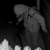 Suspect in jacket and backpack