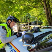 An officer writes a ticket during Go By Bike Week.