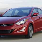 A stock photo of a burgundy Hyundai Elantra.