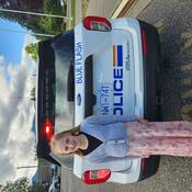Photo of student standing beside "Blue Flash"