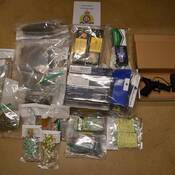 Overview of the illicit drugs, cash, contraband cigarettes and prohibited, unregistered handgun, seized from the search warrant.
