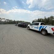 A police motorcycle and unmarked SUV parked alongside CVSE as part of a road safety surge on Highway #24