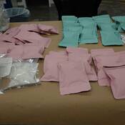 Packages of methamphetamine found inside the suitcase and on display on a desk