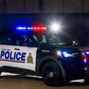 An RCMP police vehicle with emergency lights activated.
