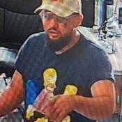 Both persons of interest had dark hair and facial hair and were approximately 5-foot-10. One man was wearing glasses, a tan ball cap with a beer logo, and a “Simpsons” t-shirt. He had a mole on the right side of his face.