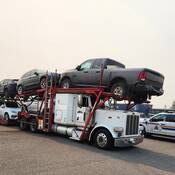 This auto transport tractor failed safety inspections after the driver was stopped for excessive speeding. BC Highway Patrol vehicles are in the background