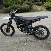 An e-dirt bike parked in a parking lot.