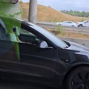 A screen shot from police video where the driver of a Tesla was spotted with his eyes closed and both hands in his lap on Highway #1 in Langley