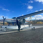 Photo of RCMP and Conservation Officer reading the RCMP Float Plane for the trip