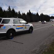 A crumpled yellow police vest marks the spot where a BC Highway Patrol officer was injured as Tobin Haas fled a traffic stop