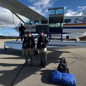 RCMP Pilot Longpre and two Conservation Officers ready for Operation Swamp Donkey, standing alongside the RCMP Float Plane