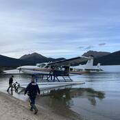 RCMP and Conservation Officers boarding the RCMP Float Plane at a remote lake in the Skeena Region