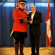 Volunteer John Petty receiving award from BC RCMP A/Commr. Brewer