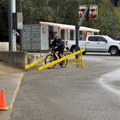 Photo of a Massett RCMP officer demonstrating how to get through the obstacle course.