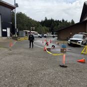 Photo of a Massett RCMP officer standing next to the obstacle course set up for students at Chief Matthews School.