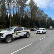 A Department of Fisheries and Oceans truck and a BC Highway Patrol vehicle at a joint force check stop near Terrace