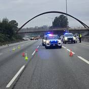 BC Highway Patrol cruisers parked on the highway while investigators work in the background