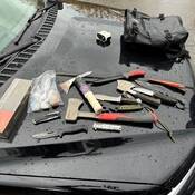 Image of knives, axes and drugs.