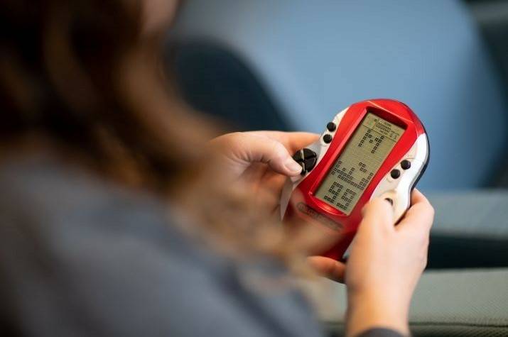 A woman’s hands playing a video game.
