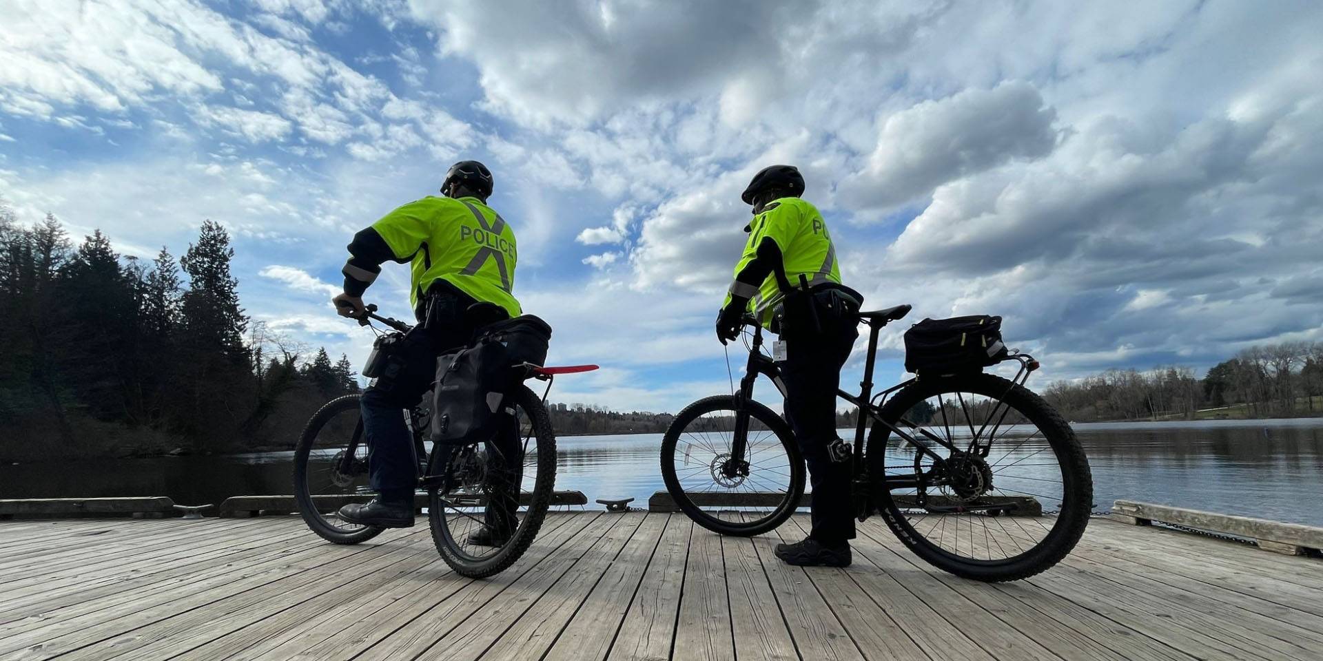 Two officers on bike patrol overlooking lake