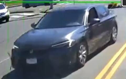 grey/silver four door Honda Civic driving on the road. Unknown plate and cannot see driver.