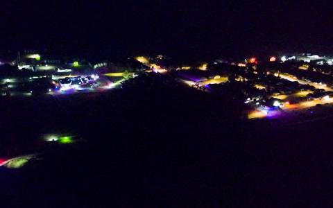 This drone photo shows the town of Richmound at night with numerous police lights and police vehicles.
