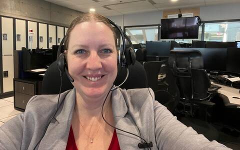 Tammy Bouwman smiling while wearing a headset indoors