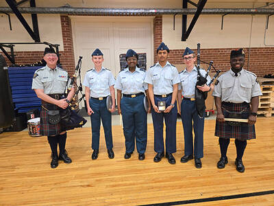 S/Sgt. John Llambias poses with the members of the youth teaching program.
