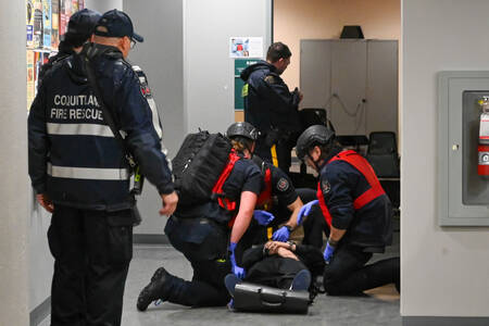 Coquitlam RCMP collaborates with Coquitlam Fire Rescue to assist a person during a training exercise.