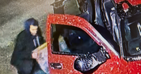 Surveillance image of suspect and red Chevrolet pickup truck in Lower Portage, New Brunswick