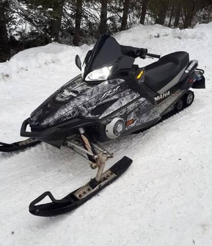 Black and camouflage 2003 Yamaha RX10HB snowmobile stolen from Baker Brook, New Brunswick