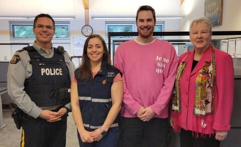 RCMP officer with 3 Victim Services volunteers