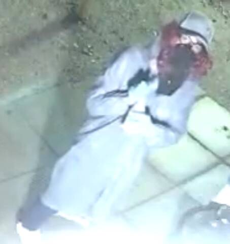 Disguised suspect who spray-painted outdoor security cameras at a Rapid City convenience store on May 23, 2026