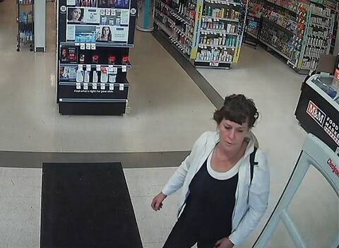Woman walking out of Rexall Drugs