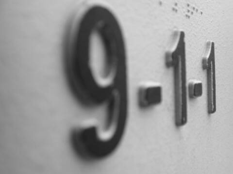 The numbers 9-1-1 on a grey background