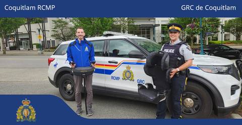 City of Coquitlam employee and RCMP officer holding car seats while standing in front of a marked police vehicle