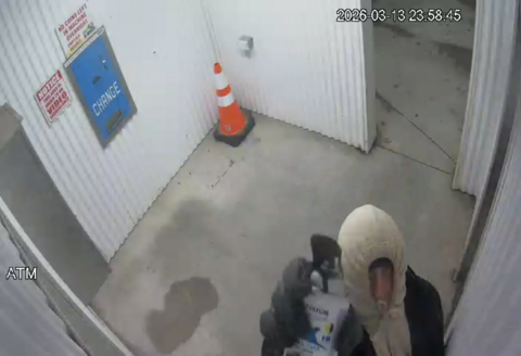 Surveillance image of suspect in hoodie and gloves involved in theft at Clarenville U-Wash car wash