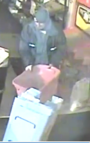 Surveillance image of suspect in Lethbridge hardware store break and enter carrying a red plastic bin