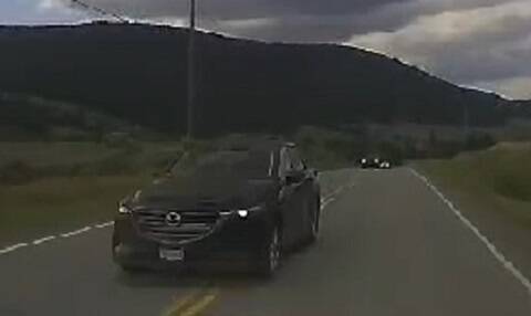 Thumbnail: Photo of a black vehicle over the centre line on roadway