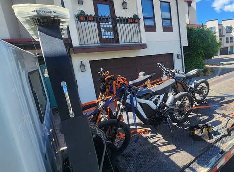 E-Dirt Bikes on flatbed tow truck