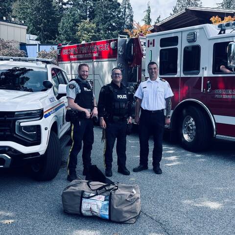 Police officers standing with Sechelt Fire Department