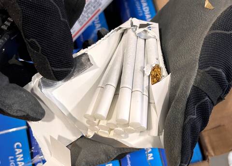 Photo of a person holding the seized cigarettes.