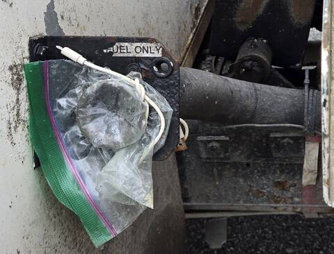 A sandwich bag is secured around the end of a fuel line by a cellular phone charging cable, essentially replacing the fuel cap.