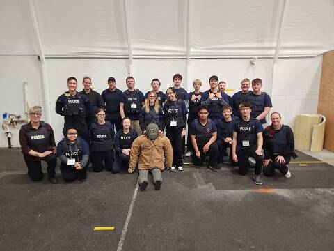 A group of students sitting on the ground