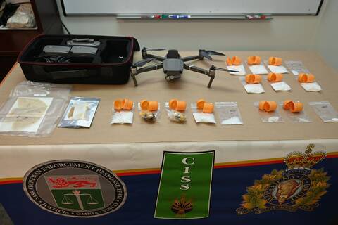 Small bags of illicit drugs and a drone on a table