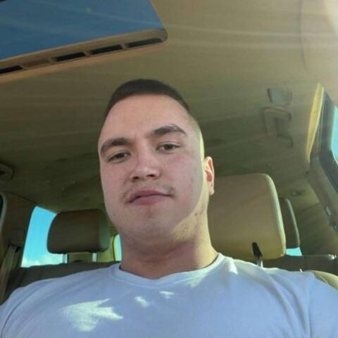 Photograph of Kevin Danais with crew-cut dark brown hair wearing a crew necked shirt