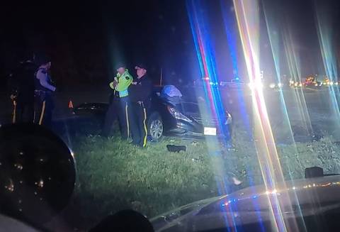 RCMP investigators at the scene of a fatal collision involving a black Hyundai sedan and a white Hyundai SUV